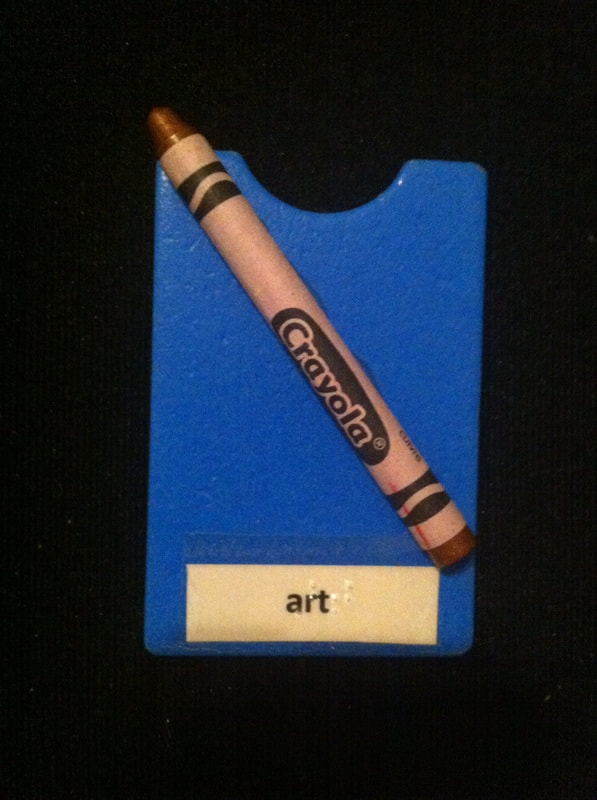Art label with crayon glued to card