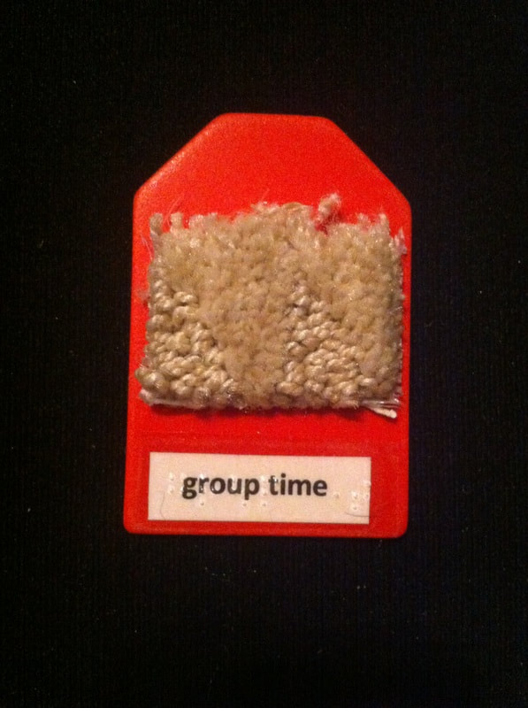group time label with a piece of carpet glued to label
