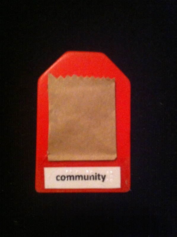 community label with the top of a grocery bag glued to card
