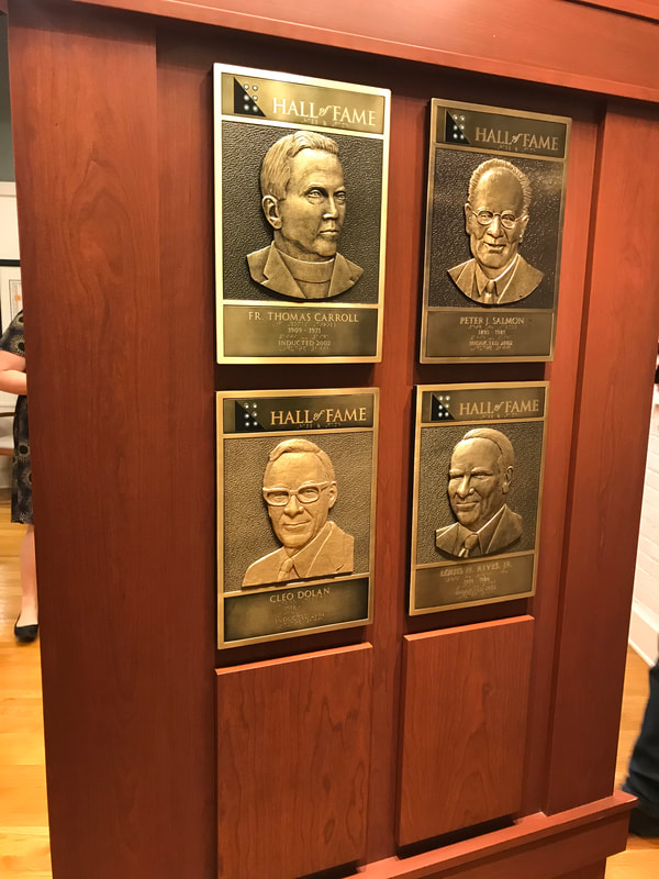 plaques of inductees Fr. Thomas Carroll, Peter J. Salmon, Cleo Dolan, Louis H. Rives, Jr.