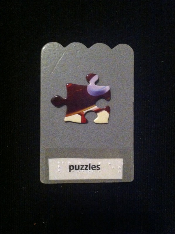 puzzles label with a puzzle piece glued to card