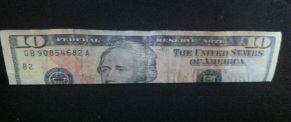 Picture of a ten dollar bill folded lengthwise.