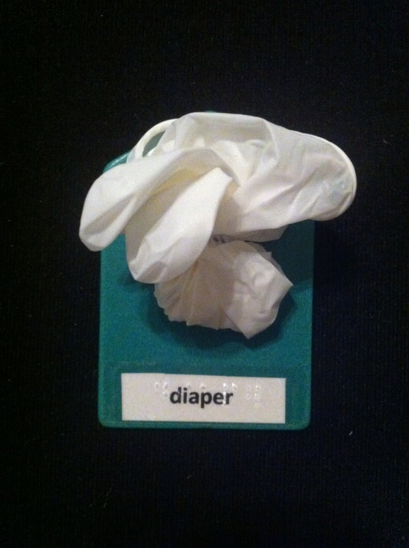 diaper label with a rubber glove glued to the card