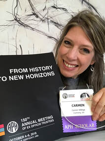 Carmen Willings holding 150th Annual Meeting Agenda and APH Scholar namebadge